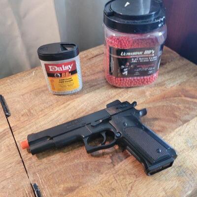 Airsoft spring load pistol and 2 mostly full jars of BB's