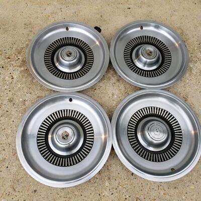 LOT #19. Set of four vintage Buick Electra hubcaps, 60s.