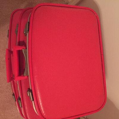 LOT #20. Vintage red four piece suitcase/luggage set.