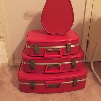 LOT #20. Vintage red four piece suitcase/luggage set.