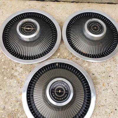 LOT #21. Three vintage Thunderbird hubcaps, + one similar, 60s