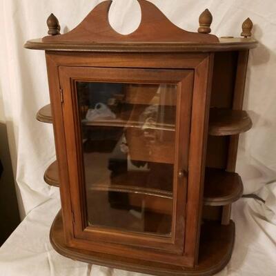 LOT #57. Small wooden curio cabinet with glass door.