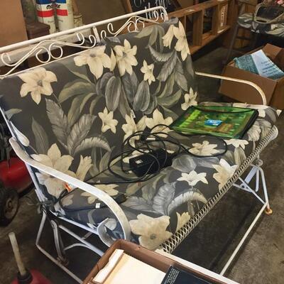 LOT #65. Vintage white wrought iron glider with cushions. 