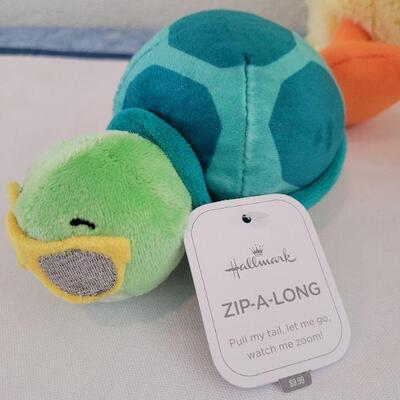 Lot 59: New (2) Hallmark Zip-a-long Plushies and Animated Duck