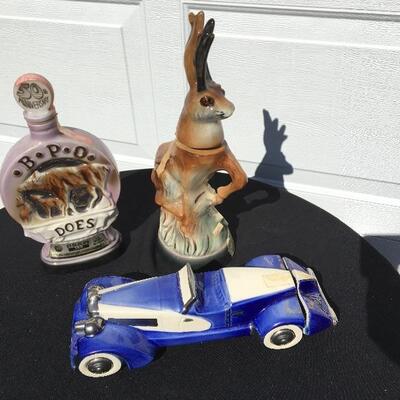 JIM BEAM Collection of three collectible bottles 12 to 14 inches with stag and race car