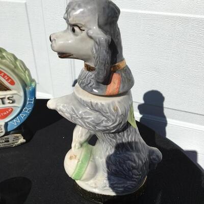 JIM BEAM Collection of four collectible bottles 12 to 14 inches with poodle and race car