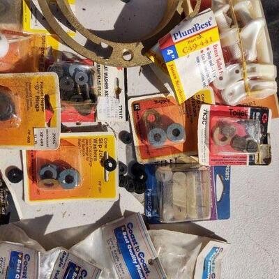 lot 11 - Plumbing parts, brass flange, toilet ball, hinges, joints, washers, valves, etc.