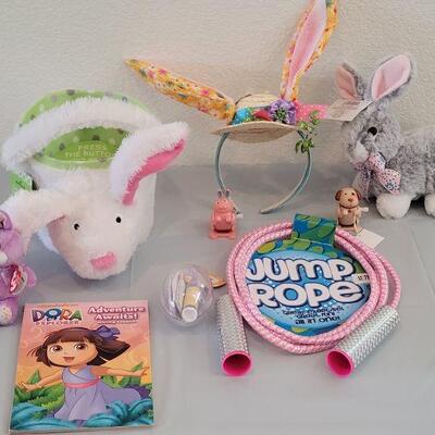 Lot 234: New Flapping Ears and Singing Bunny Basket, Jump Rope, Activity Pad, Bunny Ears Headband, Lip Balm, Wind Up Toys and Ty Beanie...