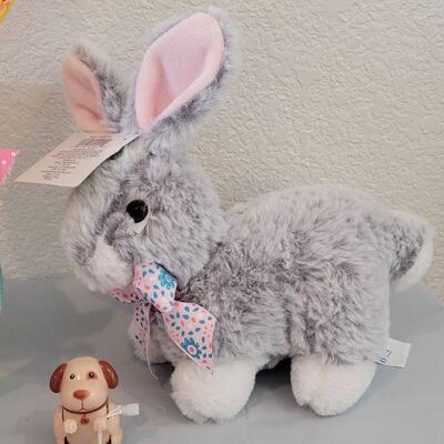 Lot 234: New Flapping Ears and Singing Bunny Basket, Jump Rope, Activity Pad, Bunny Ears Headband, Lip Balm, Wind Up Toys and Ty Beanie...