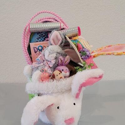 Lot 234: New Flapping Ears and Singing Bunny Basket, Jump Rope, Activity Pad, Bunny Ears Headband, Lip Balm, Wind Up Toys and Ty Beanie...