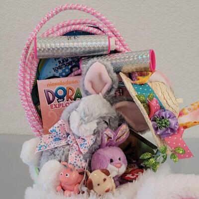 Lot 234: New Flapping Ears and Singing Bunny Basket, Jump Rope, Activity Pad, Bunny Ears Headband, Lip Balm, Wind Up Toys and Ty Beanie...