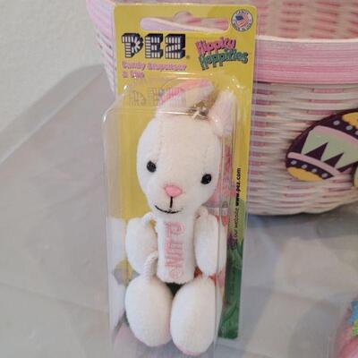 Lot 316: New Easter Basket filled with Lip Balm, Zip a long, Stickers, Chalkboard Placemat Pez, Sculpt n Soap, Goo Egg, Squishmallow and...