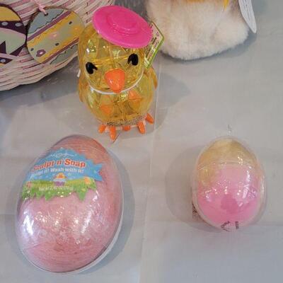 Lot 316: New Easter Basket filled with Lip Balm, Zip a long, Stickers, Chalkboard Placemat Pez, Sculpt n Soap, Goo Egg, Squishmallow and...