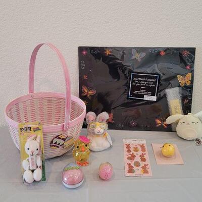 Lot 316: New Easter Basket filled with Lip Balm, Zip a long, Stickers, Chalkboard Placemat Pez, Sculpt n Soap, Goo Egg, Squishmallow and...