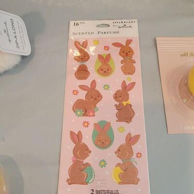 Lot 316: New Easter Basket filled with Lip Balm, Zip a long, Stickers, Chalkboard Placemat Pez, Sculpt n Soap, Goo Egg, Squishmallow and...