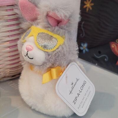 Lot 316: New Easter Basket filled with Lip Balm, Zip a long, Stickers, Chalkboard Placemat Pez, Sculpt n Soap, Goo Egg, Squishmallow and...