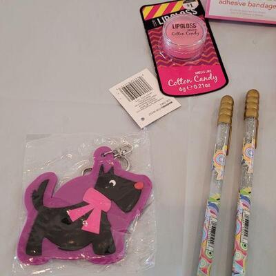 Lot 317: Hallmark Jelly Roll Rug Easter Basket and Makeup, Keychain, Gel Pens, Bandaid, Mirth Mermaid Slap Bracelet, 