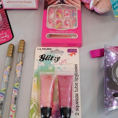 Lot 317: Hallmark Jelly Roll Rug Easter Basket and Makeup, Keychain, Gel Pens, Bandaid, Mirth Mermaid Slap Bracelet, 