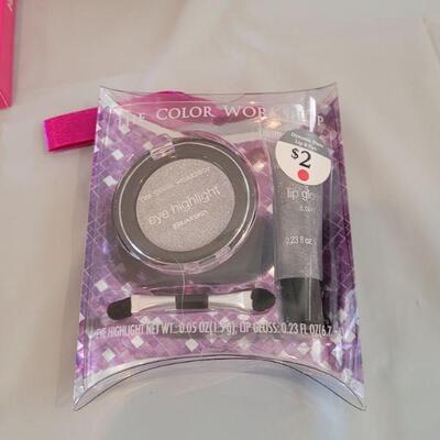 Lot 317: Hallmark Jelly Roll Rug Easter Basket and Makeup, Keychain, Gel Pens, Bandaid, Mirth Mermaid Slap Bracelet, 