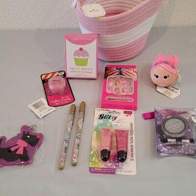 Lot 317: Hallmark Jelly Roll Rug Easter Basket and Makeup, Keychain, Gel Pens, Bandaid, Mirth Mermaid Slap Bracelet, 