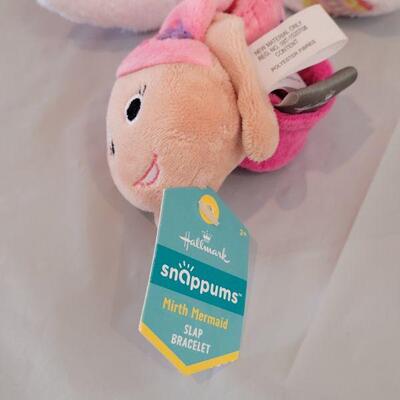 Lot 322: New Easter Basket including Chick Palm Pet,Ty Beanie Bunny, Hallmark Mirth Mermaid Slap Bracelet, Light Up Wand, Pez, Bunny Ears...
