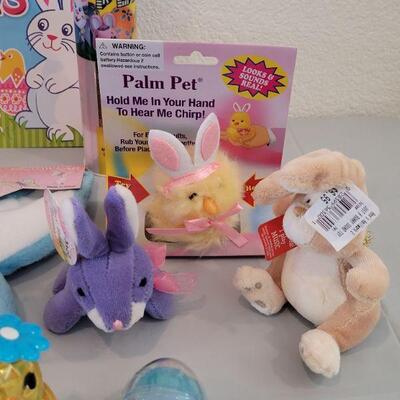 Lot 322: New Easter Basket including Chick Palm Pet,Ty Beanie Bunny, Hallmark Mirth Mermaid Slap Bracelet, Light Up Wand, Pez, Bunny Ears...