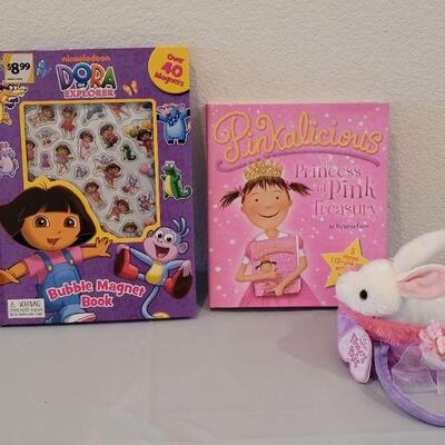 Lot 375: New Dora the Explorer Magnet Book and Pinkalicious Activities Book and a Plush Bunny in a Purse