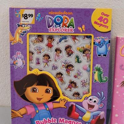 Lot 375: New Dora the Explorer Magnet Book and Pinkalicious Activities Book and a Plush Bunny in a Purse