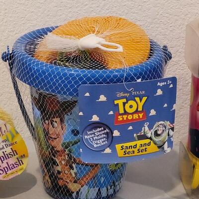 Lot 384: New Large Alphabet Magnets, Toy Story Sand & Sea Set and Animated Duck