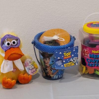 Lot 384: New Large Alphabet Magnets, Toy Story Sand & Sea Set and Animated Duck