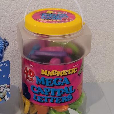 Lot 384: New Large Alphabet Magnets, Toy Story Sand & Sea Set and Animated Duck