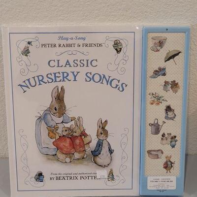 Lot 385: New Peter Rabbit Nursery Songs Book, Chalkboard Placemat and Hallmark Animated Bunny 