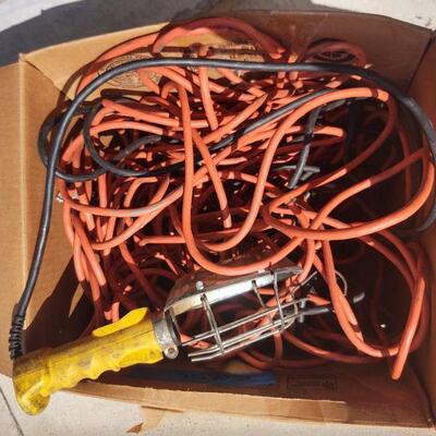 LOT 42 =-Box of heavy duty extension cords and worklight