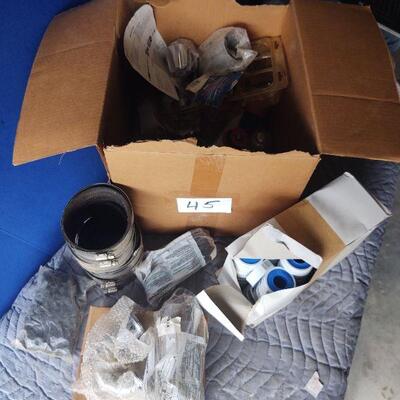 LOT 45 - Plumbing parts, Case of teflon tape, hose clamps, washers, p-trap, tub spout, faucet knobs, etc. as shown
