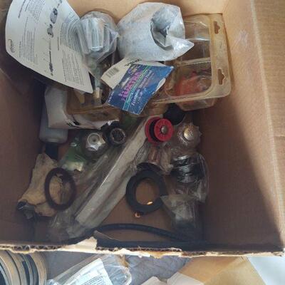 LOT 45 - Plumbing parts, Case of teflon tape, hose clamps, washers, p-trap, tub spout, faucet knobs, etc. as shown