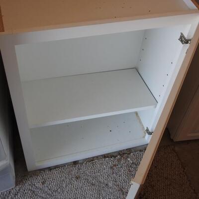 2 white storage cabinets