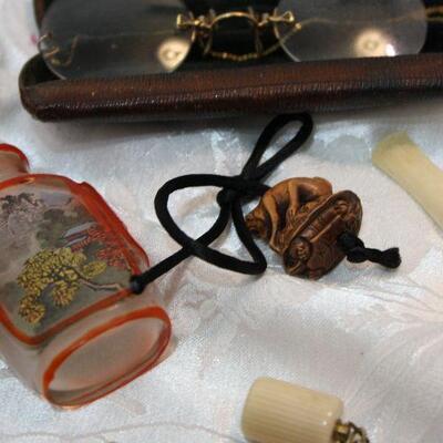 Vanity collectible lot - perfume bottles, cigarette holders, sterling pincushion