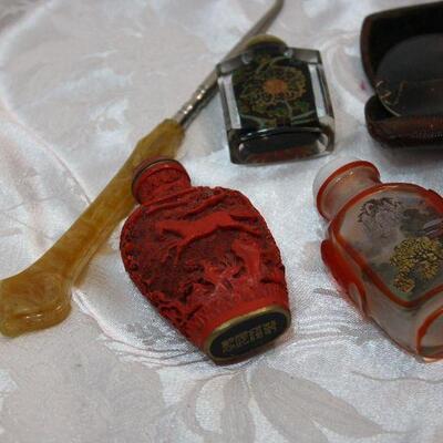 Vanity collectible lot - perfume bottles, cigarette holders, sterling pincushion