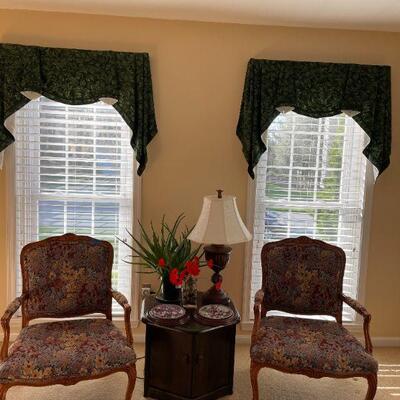 Lot 44 - Lot 44 - 2 solid wood upholstered chairs, double door wooden table, lamp, (2) Bradford plates, live aloe plant, faux plant