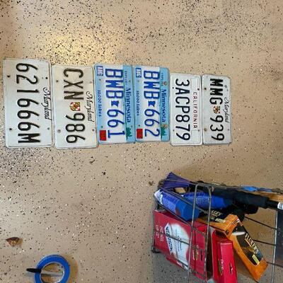 Lot 55 -  (6) vintage license plates, metal basket, level, misc. sprays and supplies