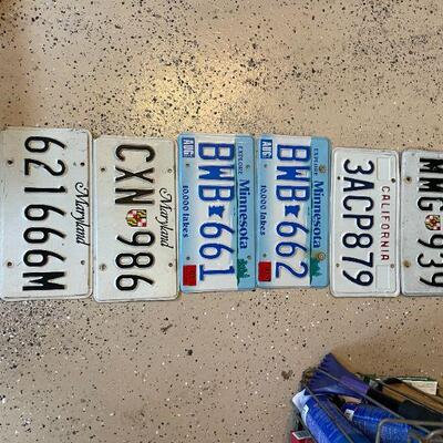 Lot 55 -  (6) vintage license plates, metal basket, level, misc. sprays and supplies