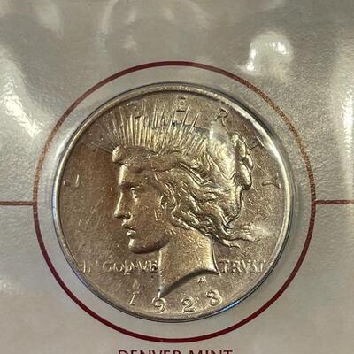 Lot 87 - 1922 peace dollar with Alexander Graham Bell stamp, 1923 Calvin Coolidge becomes president stamp, 1923 peace dollar President...