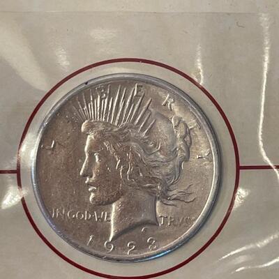 Lot 87 - 1922 peace dollar with Alexander Graham Bell stamp, 1923 Calvin Coolidge becomes president stamp, 1923 peace dollar President...