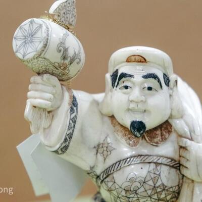 Bone Sculpture -Chinese man holding mallet 