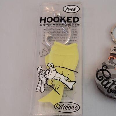 Lot 212: Keychains - 2 Cat Notepad, Cat Pouch and Fish 