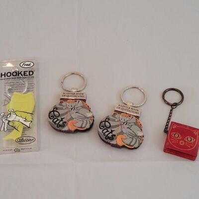 Lot 212: Keychains - 2 Cat Notepad, Cat Pouch and Fish 
