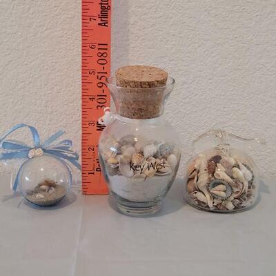 Lot 116: Glass Containers with Sand and Shells from different beaches 