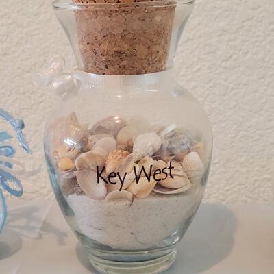 Lot 116: Glass Containers with Sand and Shells from different beaches 