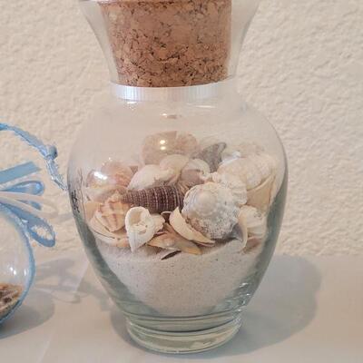 Lot 116: Glass Containers with Sand and Shells from different beaches 