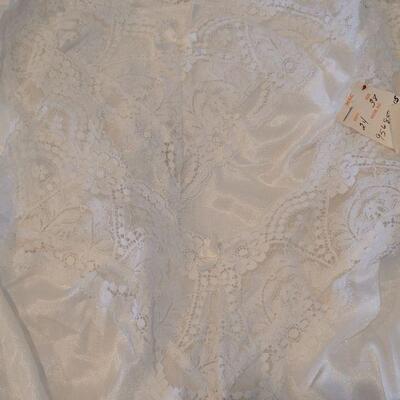 Lot 133: (4) New White Lace Trimed Camisoles and one Tan Long Lace Trimed Split Skirt Slip